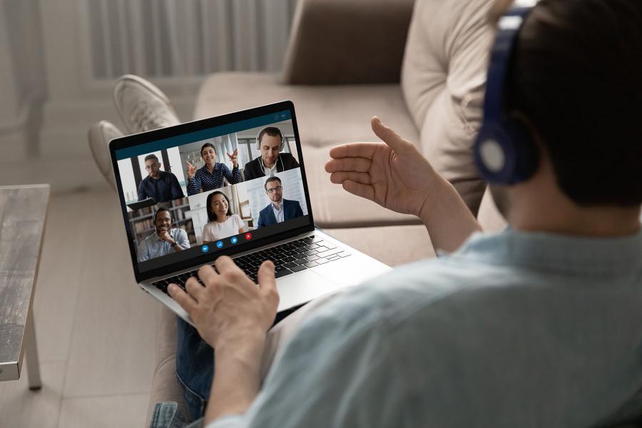 A generic photo of a person on a video call for a meeting while working from home.